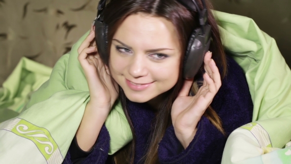 Girl With Headphones In Bed Home