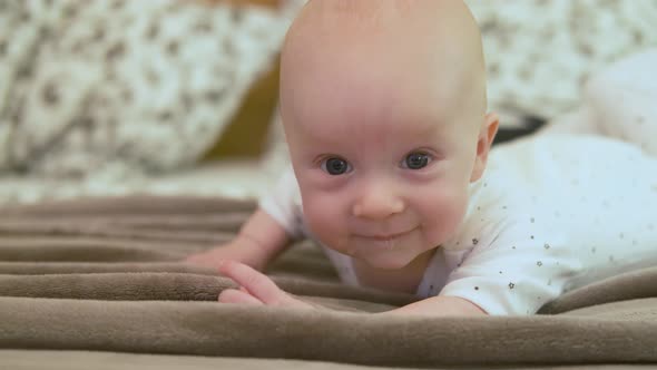 portrait of baby with saliva lying in bed