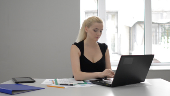 Businesswoman typing on Laptop at Work Businesswoman typing on Laptop at Work