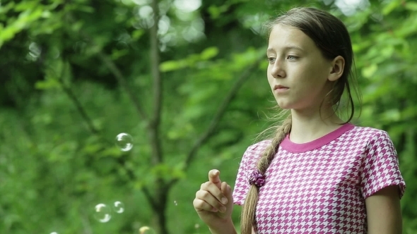 Young Girl Catches Soap Bubbles In The Park Young Girl Catches Soap Bubbles In The Park