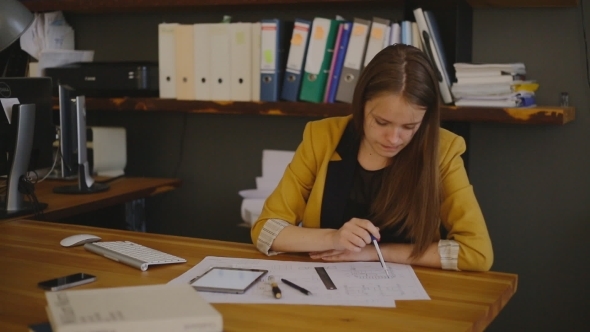 Woman Checks The Distance To The Drawings And Make Woman Checks The Distance To The Drawings And Make