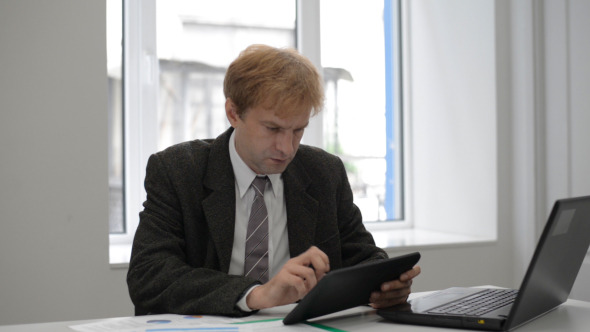 Businessman Typing on Tablet Businessman Typing on Tablet