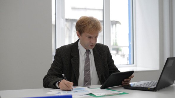 Businessman Using Tablet and Working Businessman Using Tablet and Working
