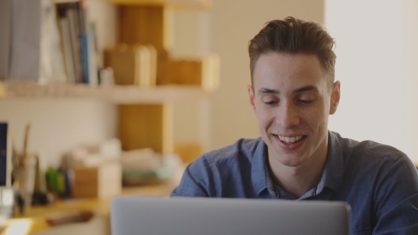 A Young Man Talking On a Conference Call A Young Man Talking On a Conference Call