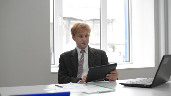 Tense Businessman Using Tablet Tense Businessman Using Tablet