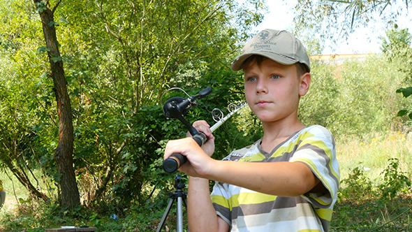 Boy Fishing With Spinning On The River Boy Fishing With Spinning On The River