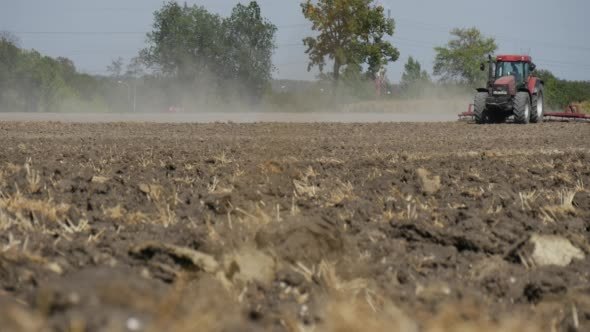 Tractor is Plowing Field Soil Driver's Silhouette Tractor is Plowing Field Soil Driver's Silhouette