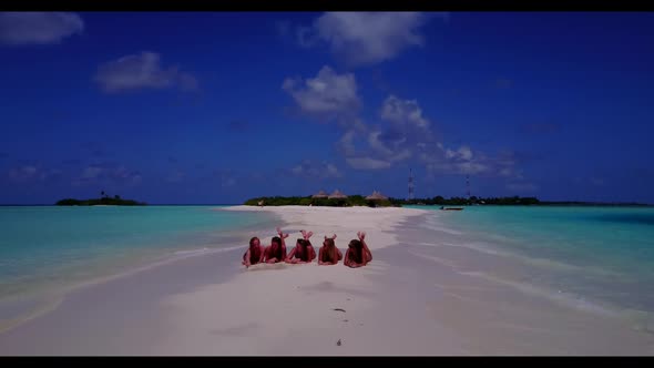 Girls relaxing on paradise shore beach lifestyle by blue ocean and white sand background of the Mald alt