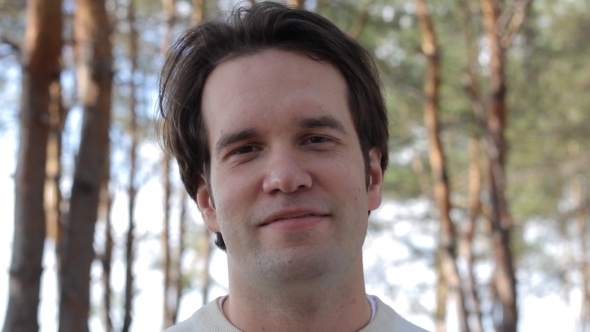 Smiling Man On The Forest Background