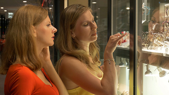 Two Girls Looking At Showcase With Jewelry