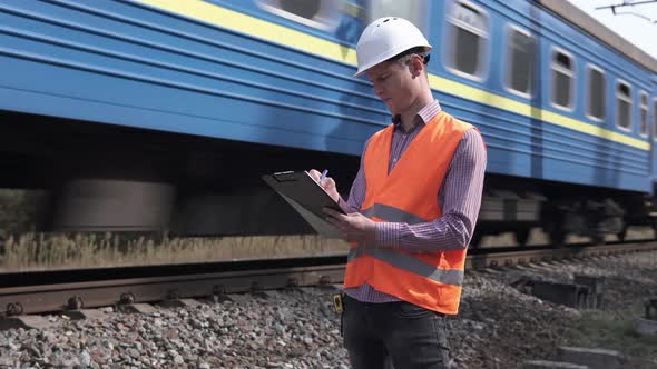 Railway Engineer Counts the Number of Sleepers and Writes in a Notebook alt