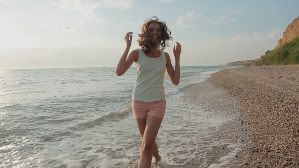 Beautiful Smiling Girl Quickly Walking On The Sea alt