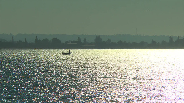 A Fisherman in a Boat at Night alt