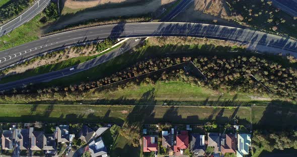 Vehicles moving in a single file toward the entrance to major carriage way of highway as seen from a alt