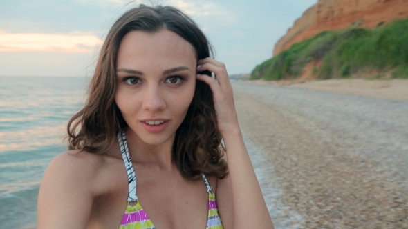 Cheerful Girl Wearing a Bikini Records Video On alt
