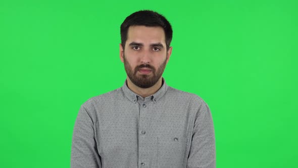 Portrait of Brunette Guy Looking Straight and Smiling. Green Screen alt