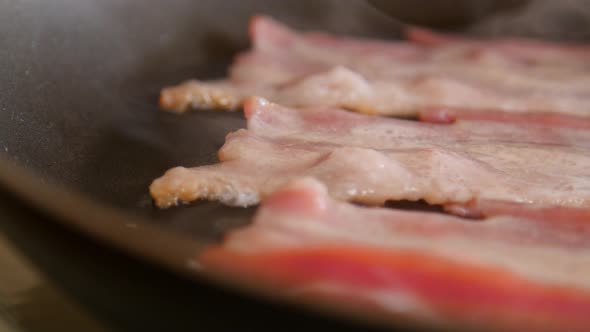 Sizzling Bacon in Frying Pan alt