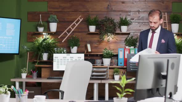 Businessman with Clipboard in Hands Walking in the Office alt