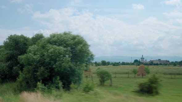 View From Window of Highspeed Train on Landscape of Beautiful Nature Wild Field and Mountains on alt