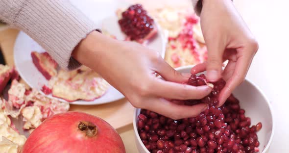 Pick pomegranate seed into glass alt