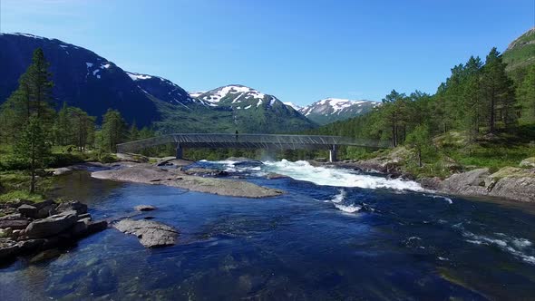 Girl watching waterfall in Norway alt