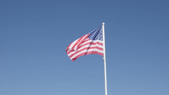 Against blue sky USA national symbol on pole in slow-mo 1920X1080 HD footage - Slow motion   United  alt