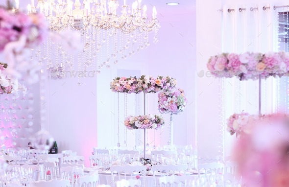 Beautiful flower decorations on elegant table with crystal chandelier