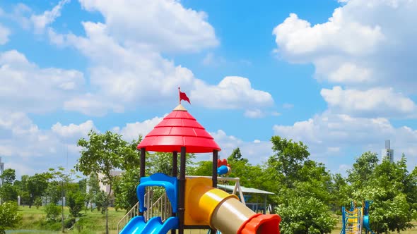 4k timelapse,clouds move or running over playground in the garden alt