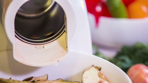 Fresh Aubergines In Chopping Machine In Action  