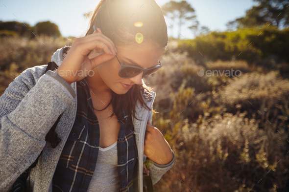 Young woman hiking on a sunny day - Stock Photo - Images