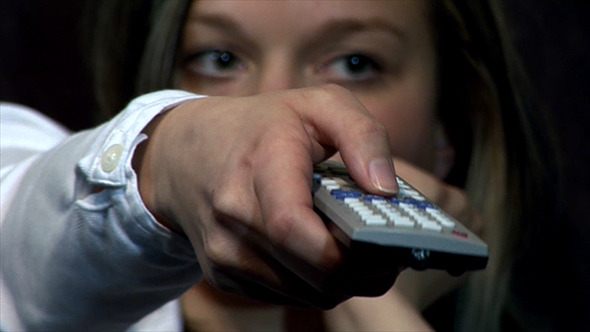 Portrait Of Woman Holding Remote Control