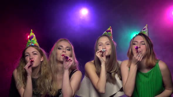 Girls Blowing Party Whistle and Dance at Party. Slow Motion alt