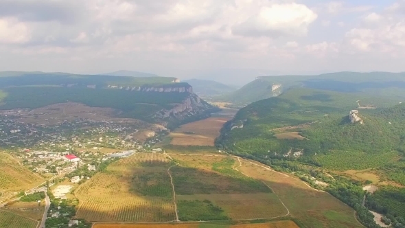 Aerial Panorama Of Hilly Locality And Harvest