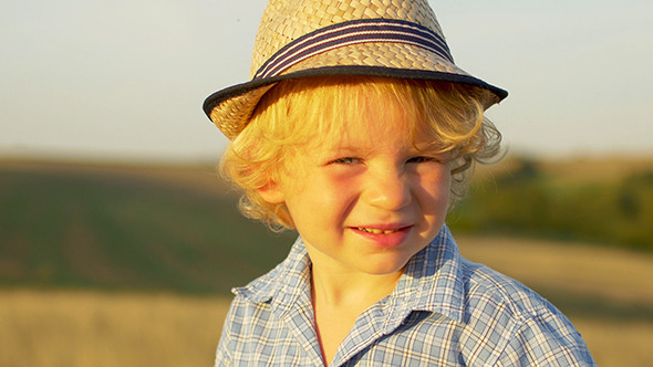 Caucasian Little Boy In A Summer Hat Outdoors