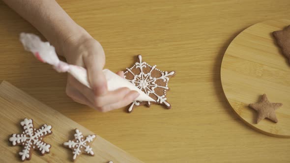 The process of decorating Christmas cookies is in motion