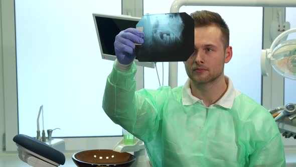 Dentist Raises X-ray To the Light alt