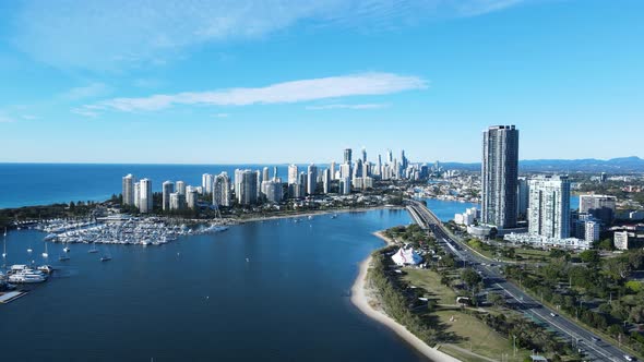 High panoramic view of a growing metropolitan skyline and city infrastructure built on a coastal wat alt