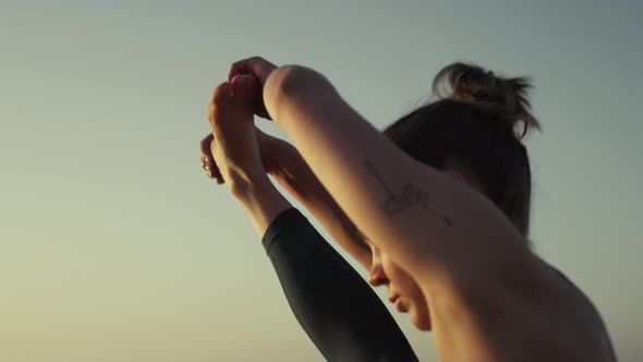 Woman Practicing Gymnastic Twine at Dusk Close Up alt