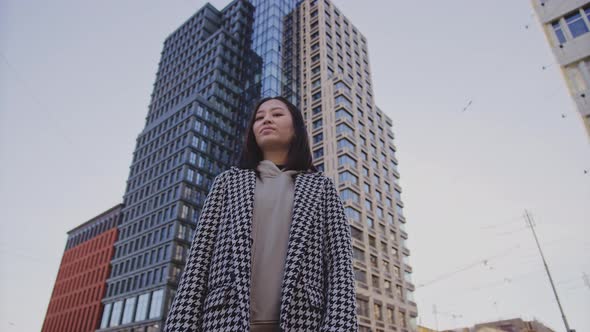 Lowangle Portrait of a Young Adult Asian Woman in Downtown District alt
