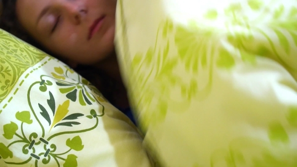 woman sleeping in a comfortable bed