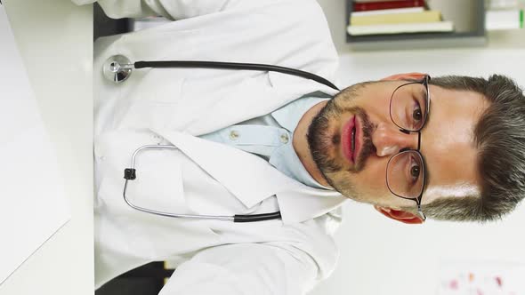 Doctor Discussing Health of Patient Through Video Call and Showing Bye Gesture alt