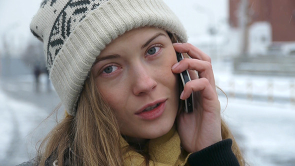 Happy Woman In Winter Wear Using Cell Phone