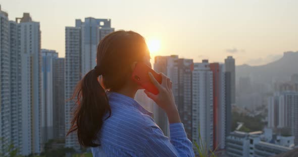 Woman look at the building and think in city of Hong Kong alt