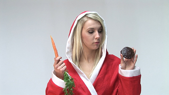 Playful Young Woman With A Carrot And Cookie