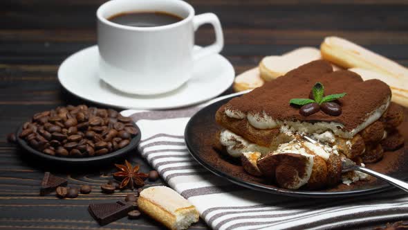 Portion of Classic Tiramisu Dessert and Savoiardi Cookies on Wooden Background alt