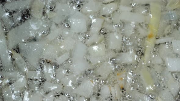 Top View of Finely Chopped Onion Fried in Vegetable Oil in Frying Pan