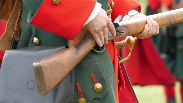 The Guard in Red Uniform Holding his Gun 