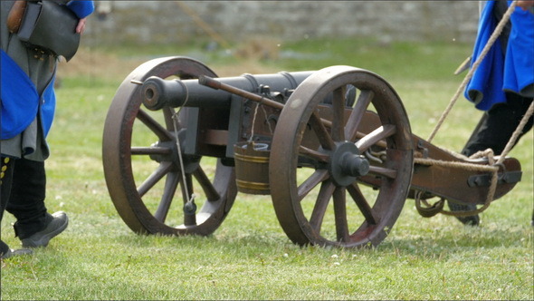 Two Guards Pulling the Black Cannon on the Ground 