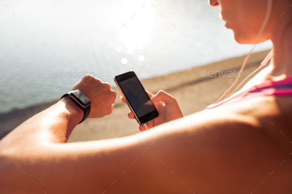 Sportswoman using smart devices - Stock Photo - Images