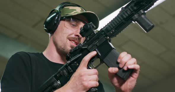 A Man Disarms the Gun By Removing the Magazine and Emptying the Chamber alt